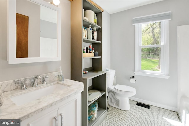 bathroom featuring tile patterned floors, a wealth of natural light, toilet, and visible vents