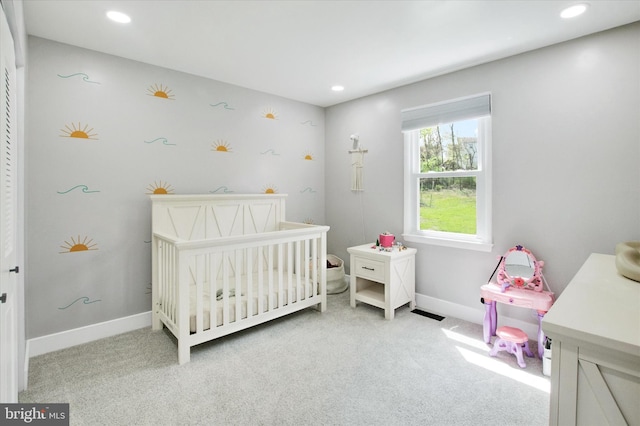 bedroom featuring recessed lighting, baseboards, carpet, and a nursery area