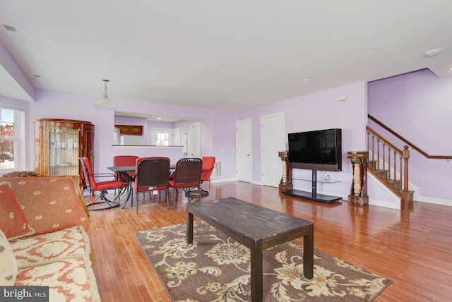 1129 Mediterranean Ave, Atlantic City, NJ 08401 - living area with baseboards, plenty of natural light, stairs, and wood finished floors