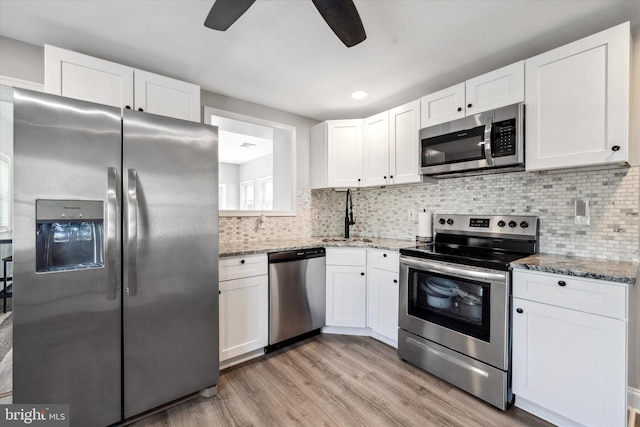 2304 Milltown Rd, Wilmington, DE 19808 - kitchen with white cabinets, a sink, light wood-style flooring, stainless steel appliances, and a ceiling fan