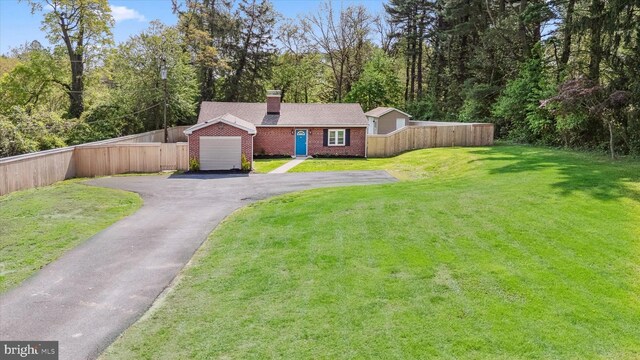 2304 Milltown Rd, Wilmington, DE 19808 - view of front of home with a chimney, a front yard, brick siding, fence, and aphalt driveway