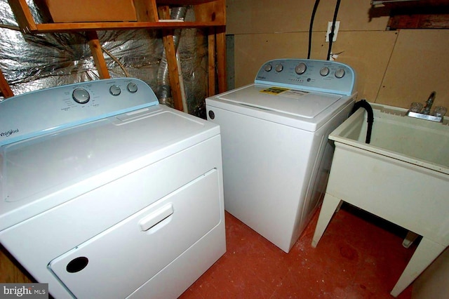 washroom with washing machine and clothes dryer and laundry area
