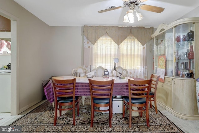 dining room featuring washer / dryer and ceiling fan