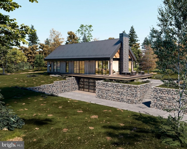 exterior space featuring a chimney, a yard, and metal roof