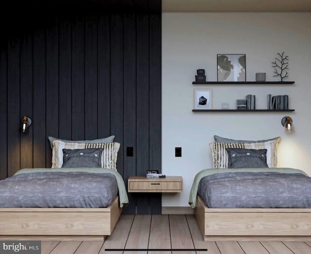 bedroom featuring baseboards and wood finished floors