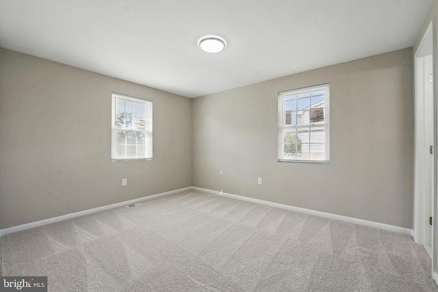 empty room with carpet flooring and baseboards