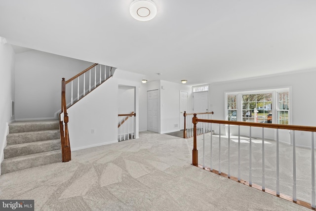 spare room with carpet floors, baseboards, and visible vents