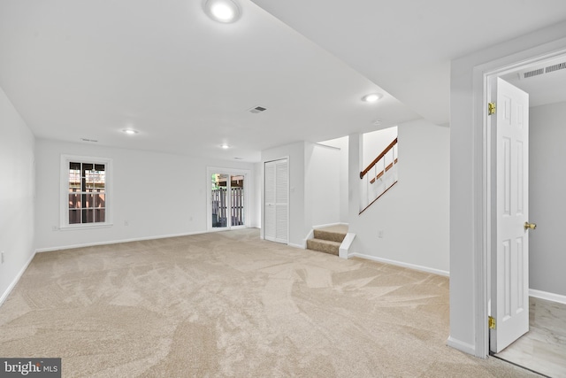 interior space featuring visible vents, baseboards, stairway, recessed lighting, and light colored carpet