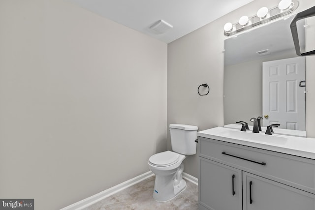 bathroom featuring baseboards, vanity, toilet, and visible vents
