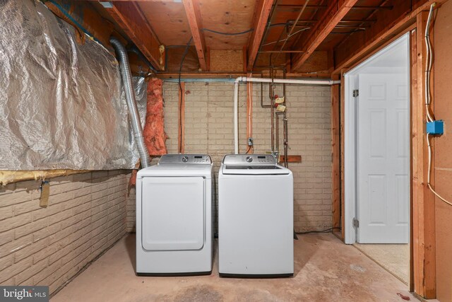 clothes washing area featuring laundry area and washer and dryer