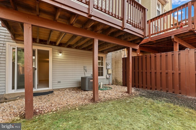 view of yard with central air condition unit, fence, and a wooden deck