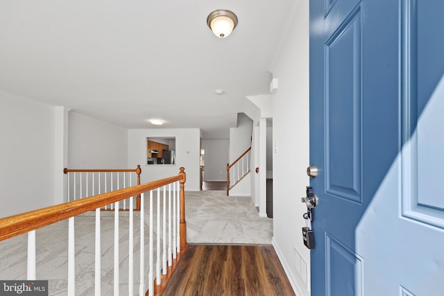 foyer featuring baseboards and dark wood finished floors