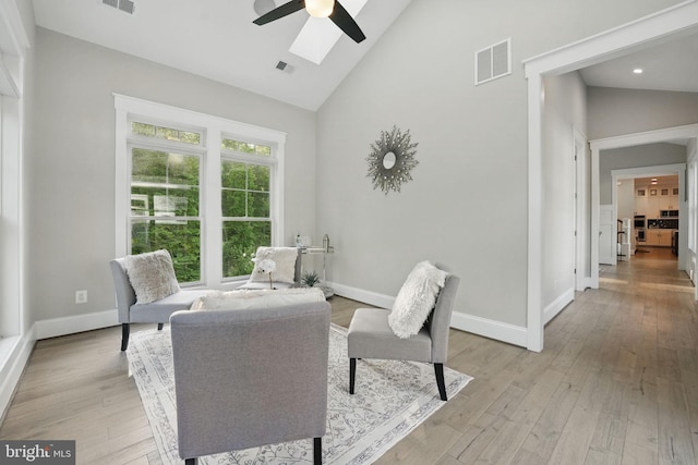 sitting room with a ceiling fan, baseboards, and visible vents