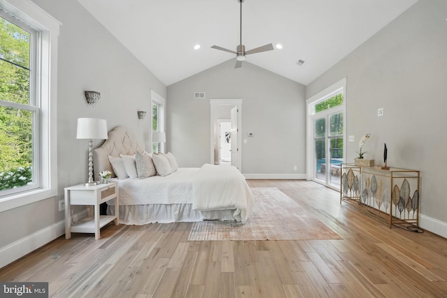 bedroom featuring access to exterior, multiple windows, and light wood-style floors