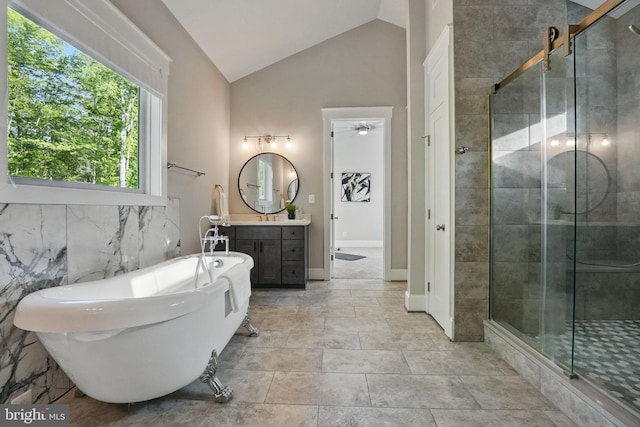 bathroom featuring vanity, ceiling fan, a soaking tub, a shower stall, and vaulted ceiling