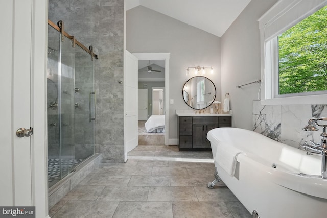 ensuite bathroom with vanity, ceiling fan, high vaulted ceiling, a soaking tub, and a stall shower
