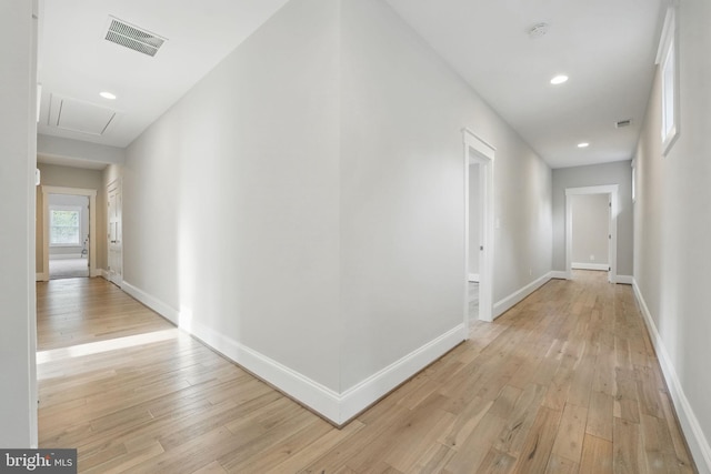 hall featuring visible vents, baseboards, attic access, recessed lighting, and light wood-style flooring