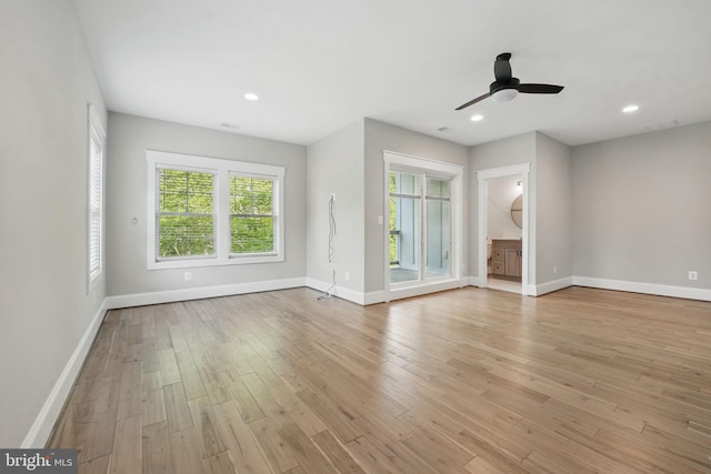 unfurnished living room featuring a ceiling fan, baseboards, recessed lighting, and wood finished floors