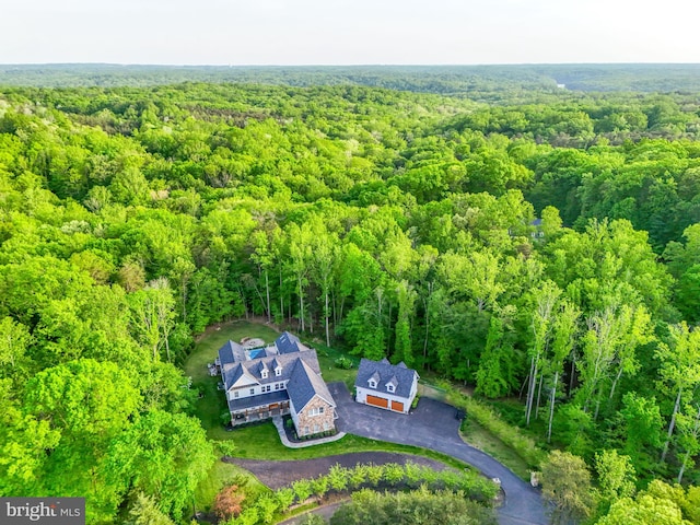 birds eye view of property with a forest view