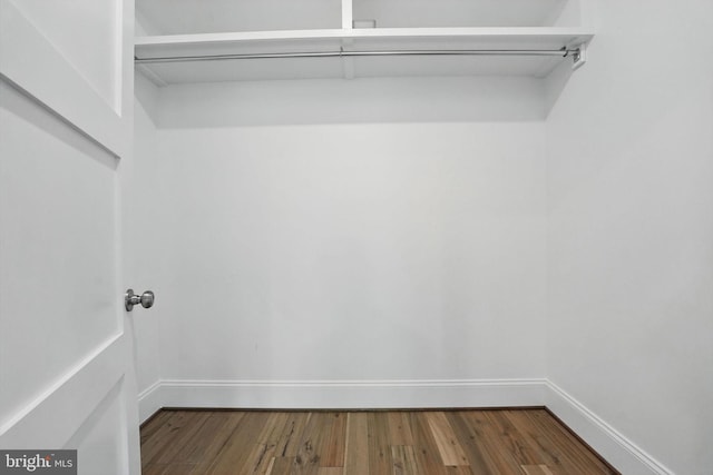 spacious closet with wood finished floors