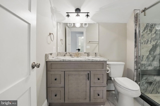 bathroom with vanity, a shower stall, toilet, and marble finish floor