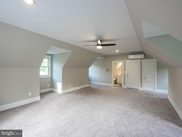 bonus room with ceiling fan, a wall mounted AC, baseboards, lofted ceiling, and carpet flooring