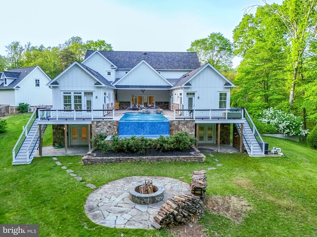 rear view of house featuring stairway, board and batten siding, french doors, and a wooden deck