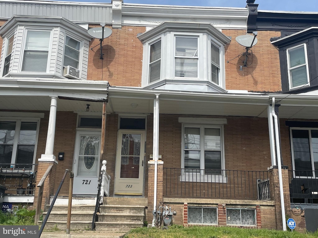 view of front of property with a porch and brick siding
