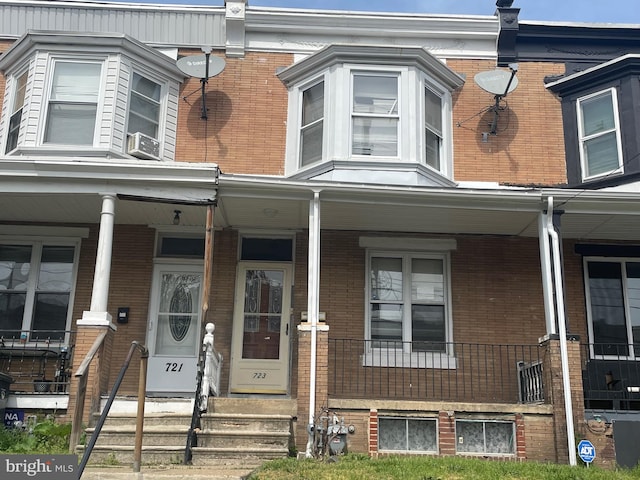 view of front of property with a porch and brick siding