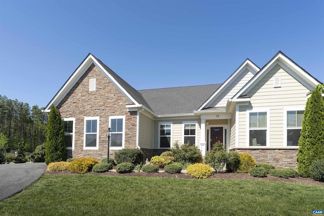 view of front of home featuring a front yard and stone siding