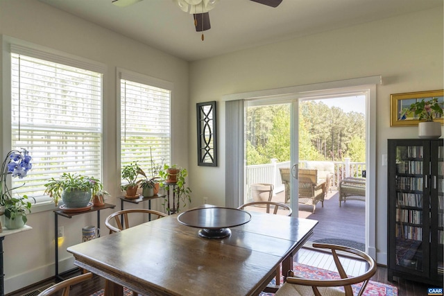 dining space with ceiling fan and wood finished floors