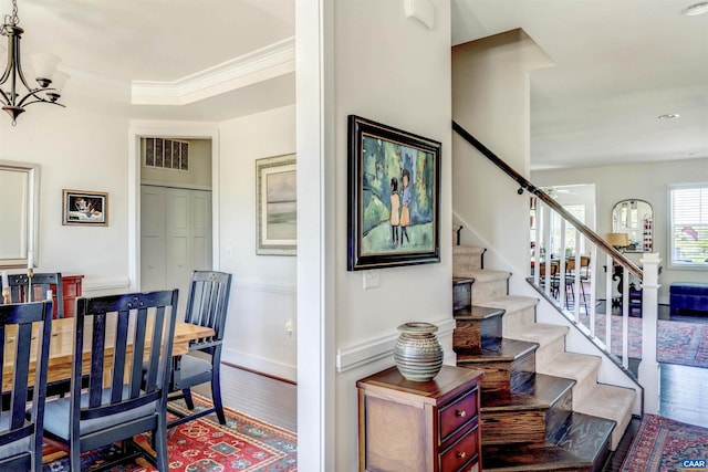 interior space with stairway, baseboards, wood finished floors, and a notable chandelier