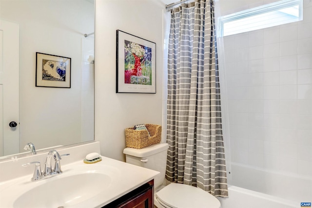 bathroom with vanity, toilet, and shower / tub combo
