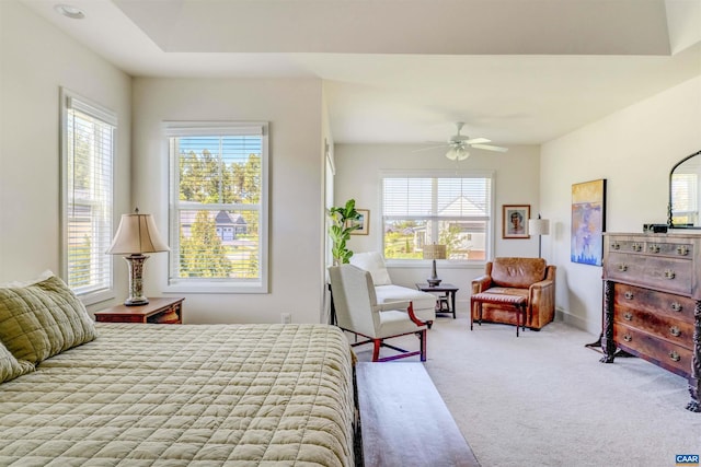 bedroom with carpet floors, multiple windows, baseboards, and a ceiling fan