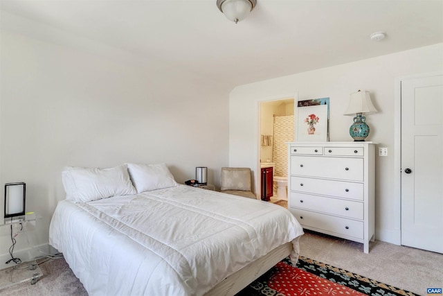 bedroom featuring carpet flooring, baseboards, and connected bathroom