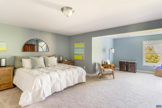bedroom featuring baseboards and light carpet