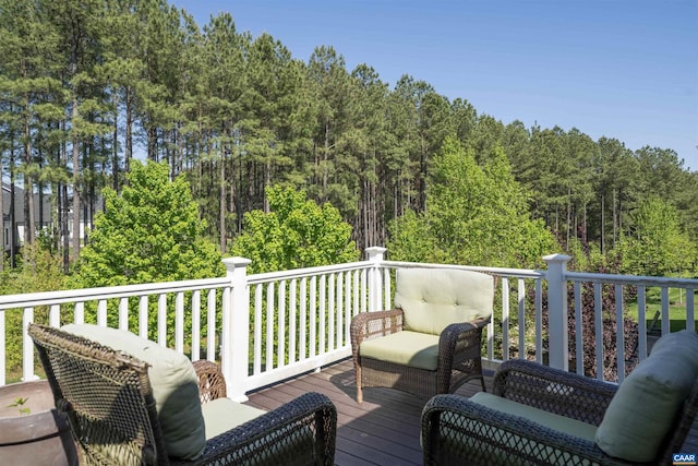 wooden deck with a view of trees