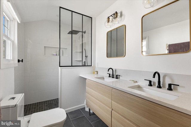 bathroom featuring a sink, tile patterned flooring, walk in shower, and toilet