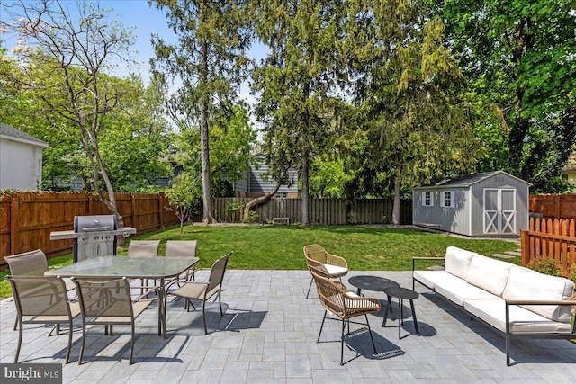 view of patio / terrace with a grill, a fenced backyard, a shed, an outdoor hangout area, and outdoor dining space