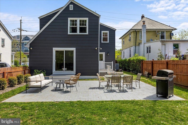back of house featuring a yard, a patio, and fence
