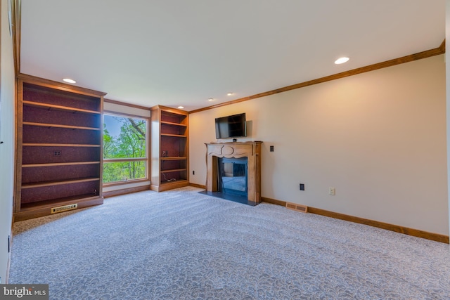 unfurnished living room with crown molding, carpet flooring, recessed lighting, baseboards, and a fireplace with flush hearth