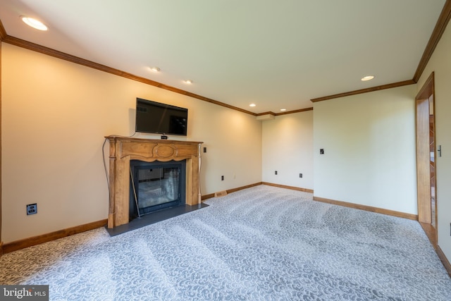 unfurnished living room featuring carpet, recessed lighting, baseboards, a fireplace with flush hearth, and ornamental molding