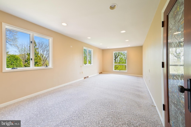 carpeted empty room with recessed lighting, baseboards, and visible vents