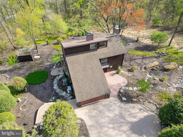 birds eye view of property with a forest view