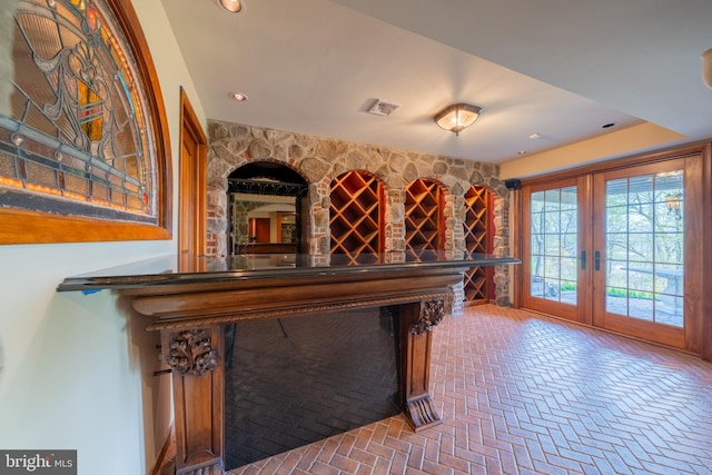 rec room featuring recessed lighting, visible vents, french doors, and brick floor