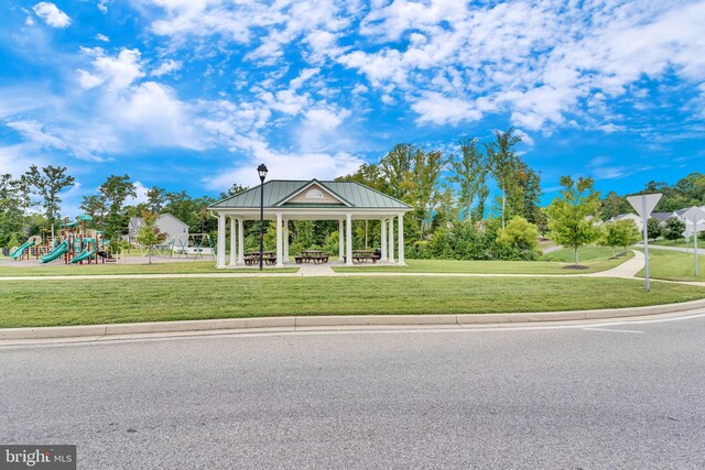 view of property's community featuring a gazebo, playground community, and a yard