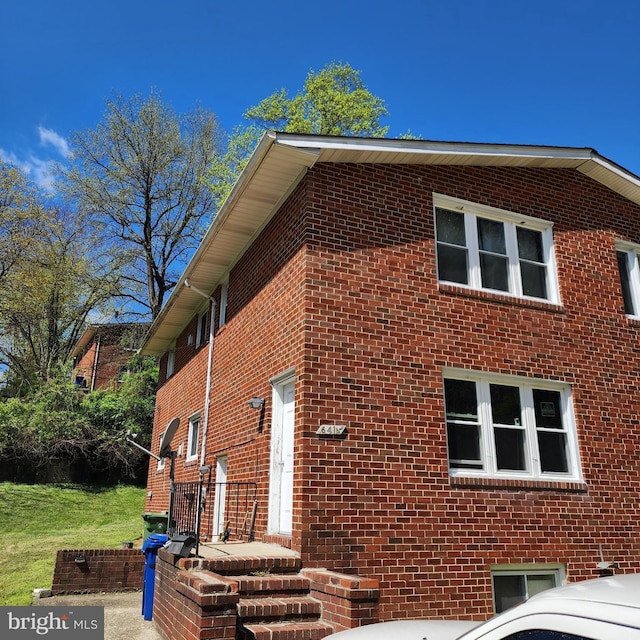 view of side of home with brick siding