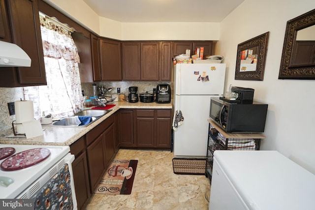 435 N St, Milford, DE 19963 - kitchen featuring dark brown cabinetry, a sink, white appliances, light countertops, and decorative backsplash