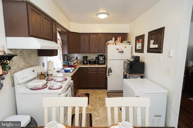 435 N St, Milford, DE 19963 - kitchen with decorative backsplash, dark brown cabinets, white appliances, light countertops, and under cabinet range hood