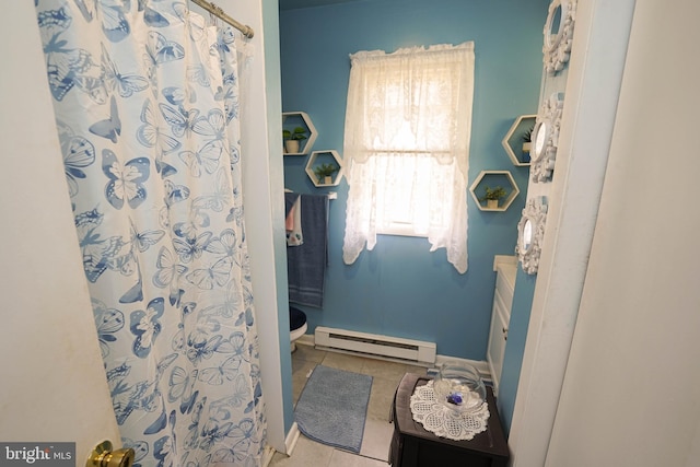 435 N St, Milford, DE 19963 - full bath featuring a baseboard radiator, tile patterned floors, toilet, and a shower with curtain
